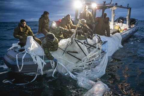 Photos capture the moment US Navy sailors pulled the downed Chinese balloon out of the ocean